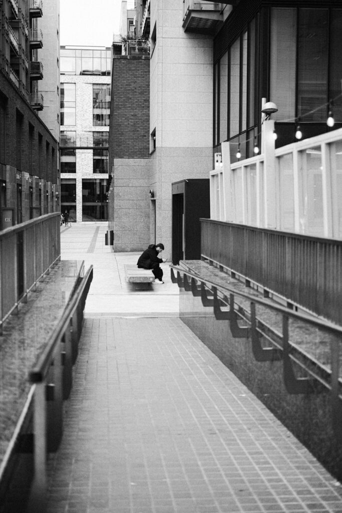 Black-and-white stairwell with a lone figure